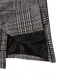 Close-up macro detail of grey plaid wool suit fabric and smooth black inner lining.