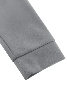 Macro view showing the grey wool-like fabric and stitching of the jacket sleeve cuff