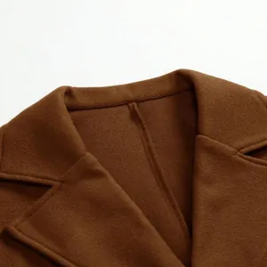Close-up detail of the notched lapel and soft fabric texture on a premium men's brown wool coat