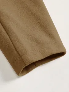 Detailed close-up view of camel wool coat sleeve cuff showing soft fabric texture