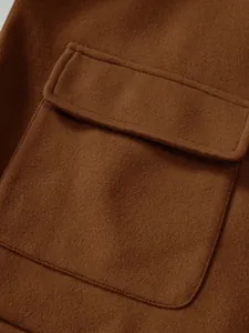 Close-up detail view showing the pocket flap and fabric texture of a brown wool jacket