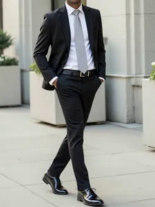 Man in a slim fit black formal suit walking outdoors for a modern business look