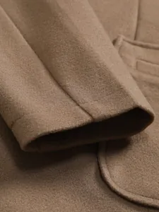 Close-up detail of the cuff and wool fabric texture of a brown men's coat