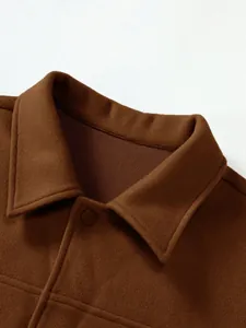 Close-up detail of a men's brown woolen jacket with lapel collar and matte button.