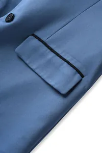 Detailed macro view of elegant blue suit jacket pocket with black piping contrast edge