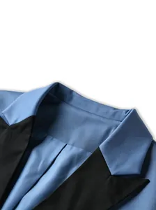 Detailed macro shot of blue men's business suit jacket featuring black peak lapels.
