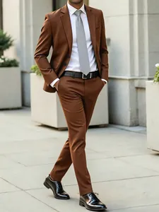 Full-length view of a tailored brown business suit for men in a modern urban setting.