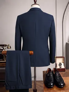 Detailed back view of a slim fit navy blue business suit set styled with luxury accessories