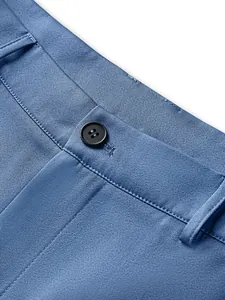 Close-up of blue formal business suit trousers waist with button and stitching detail
