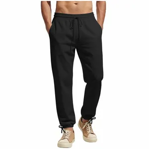 Detail view of men's black joggers featuring an elastic drawstring waist and ankle ties