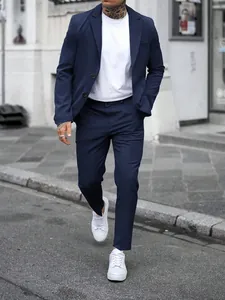 Navy blue slim fit men's business casual suit set showcased in a street fashion style