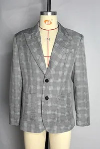 Detailed close-up of a grey Glen check men's blazer with peak lapels and two-button closure