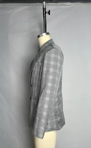 Side profile of a gray plaid blazer featuring peak lapels and a two-button design
