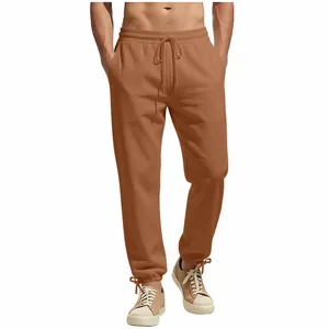 Front view of men's brown drawstring straight-leg casual trousers in a relaxed fit.