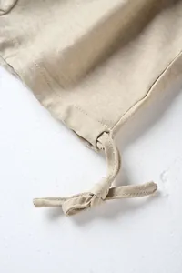 Macro view of the drawstring knot and premium textured fabric on men's casual straight trousers