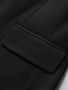 Detailed close-up view of a black men's blazer pocket showing high-quality fabric texture