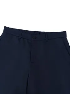 Detailed close-up view of the waistband and button on navy blue formal business suit trousers