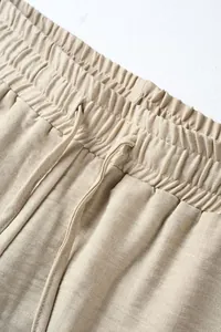 High-quality detail shot of men's casual drawstring pants showing waistband and texture