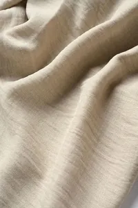 Macro detail of the breathable beige cotton-linen fabric texture for men's casual pants