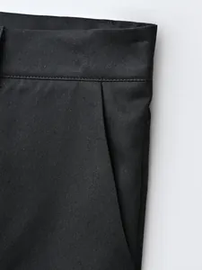 Close-up of black business suit trousers showing fabric texture and pocket detail