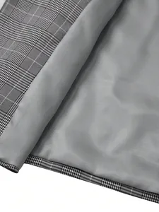 Close-up view showing the grey lining and plaid pattern of a men's suit jacket.