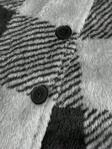 Detailed close-up showing the soft plaid plush texture and black buttons of coat