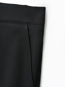 Close-up of the premium twill fabric and stitching on black business casual trousers.