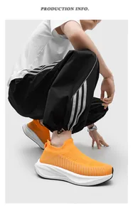 Macro shot of bright orange flyknit sock shoes featuring a thick white cushion sole