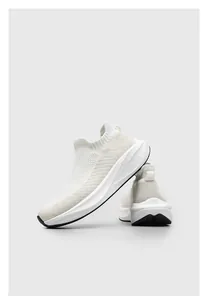 Detailed side view of breathable white mesh sock sneakers with thick comfortable soles.