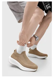 Close-up detail of khaki fly-knit sock shoes with white thick sole on model