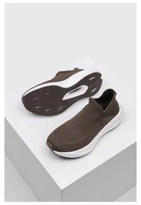 Detailed view of brown knit sock sneakers showing breathable mesh and durable textured sole