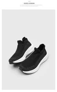 Close-up view of breathable black fly-knit sock sneakers with a thick white foam sole