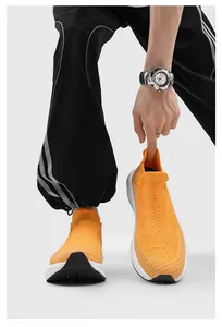Detail view of vibrant orange knit sock shoes featuring a breathable and slip-on design.