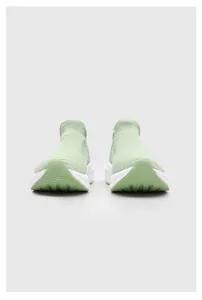 Front view of light green knitted sock sneakers featuring a thick white platform sole.