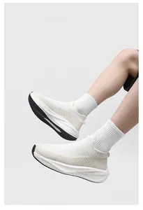 Detail view of white knit sock sneakers worn with ribbed socks