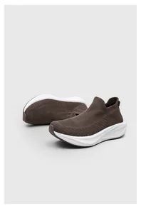Detailed side view of breathable brown slip-on sock shoes with thick white soles