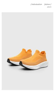 Vibrant orange slip-on sock sneakers with breathable fly-knit mesh and thick white soles