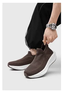 Close-up of brown knit slip-on sneakers with breathable mesh and thick white sole.
