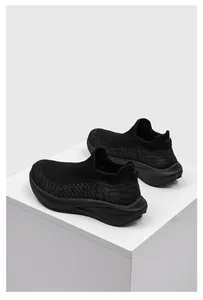 Macro view of the high-quality black breathable flying woven mesh on slip-on sneakers