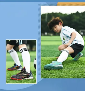 Detailed view of children's soccer shoes with rotary buckle system and turf studs.