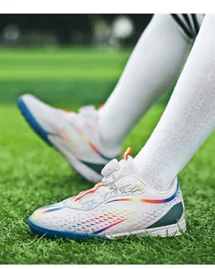 Close-up of professional children's soccer shoes with rotary buckle and vibrant patterns