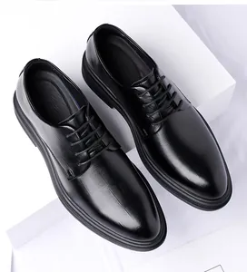 Top view of classic black men's leather business dress shoes on white pedestals