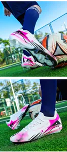 Close-up detail of professional soccer cleats with pink and black abstract design