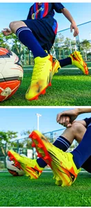 Detailed view of professional yellow soccer cleats with firm ground studs on green grass.