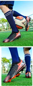 Dynamic detail of professional firm ground soccer cleats on a green football pitch