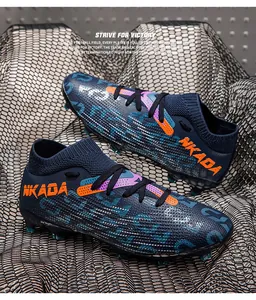Professional navy soccer cleats with flyknit collar and orange NKADA branding detail