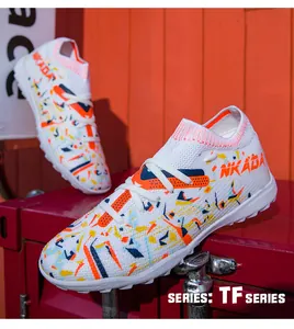 Close-up view of white flyknit soccer cleats featuring vibrant orange and blue patterns