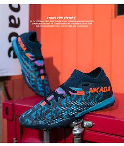 Detailed shot of fly-woven soccer cleats featuring NKADA branding and orange accents
