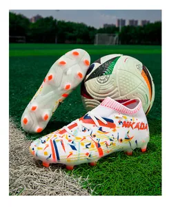 Professional flyknit football shoes with colorful patterns and firm ground orange spikes.