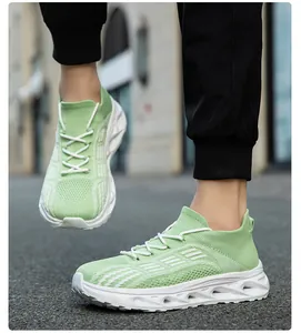 Vista dettagliata di scarpe sneaker a calzino in flyknit verde con suola bianca ammortizzata